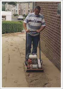 Compact the course sand with a vibrating plate