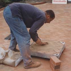 Putting kiln dried sand between the joints